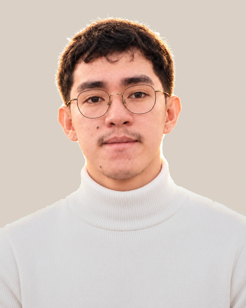 Portrait of Valkenburgh Margin in a white sweater against a light background